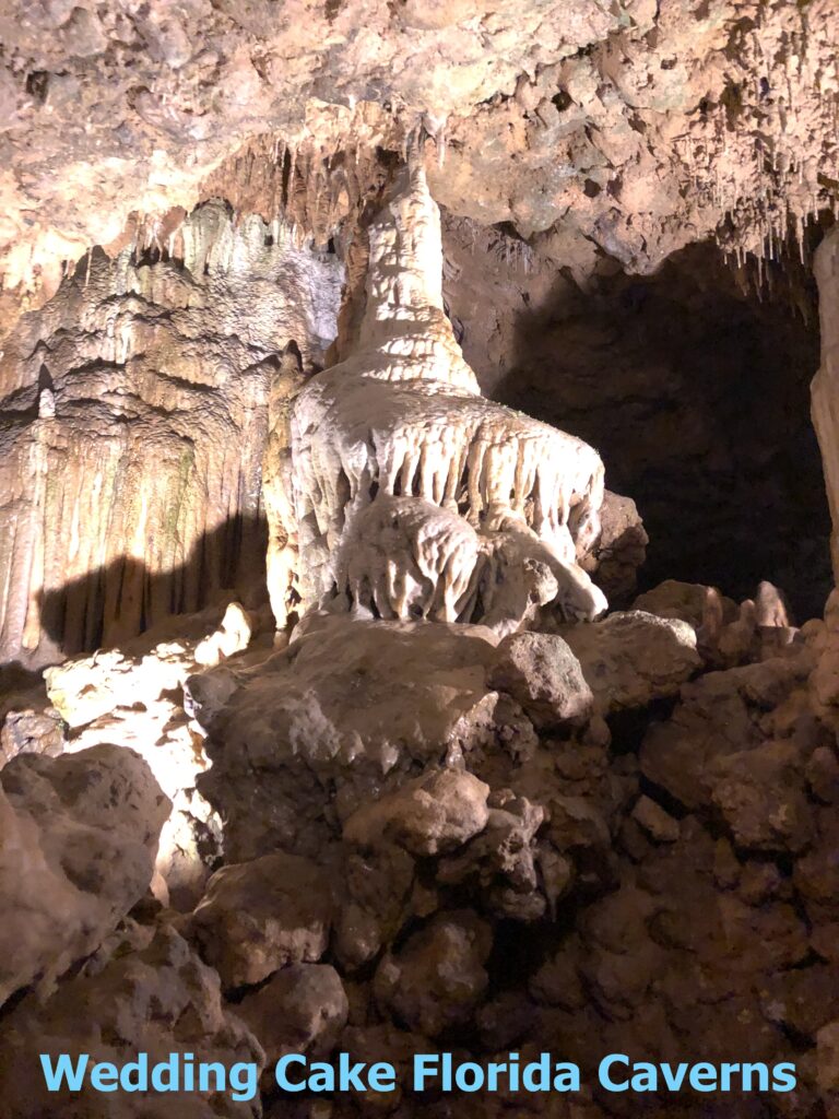 Travelers studying a detailed park trail map inside a cavern